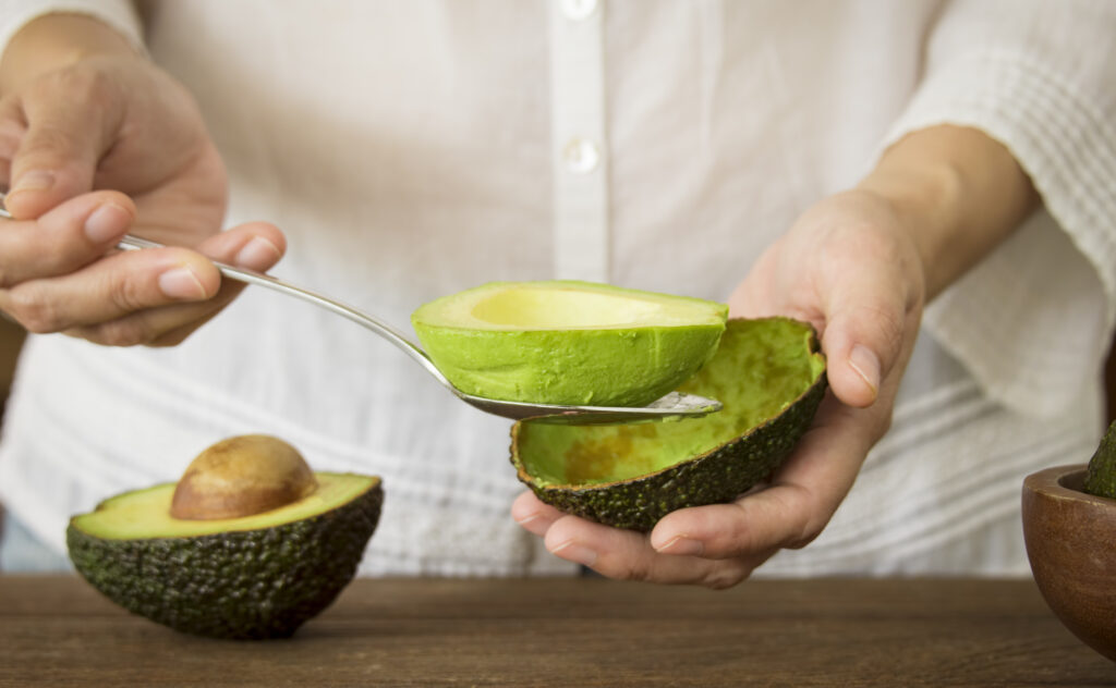 scooping avocado